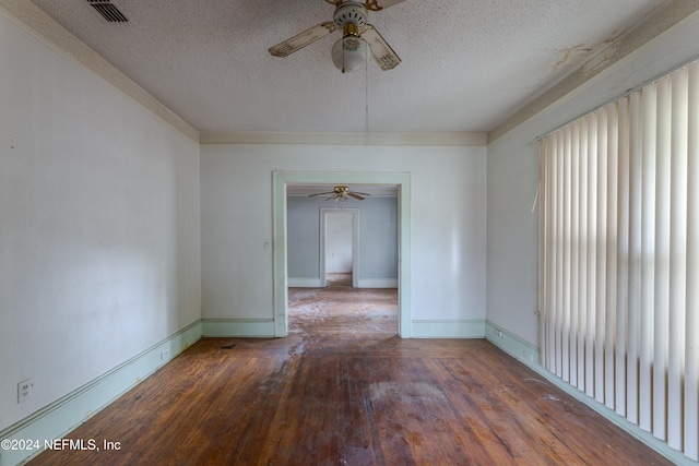 unfurnished room with ceiling fan, wood-type flooring, and a textured ceiling