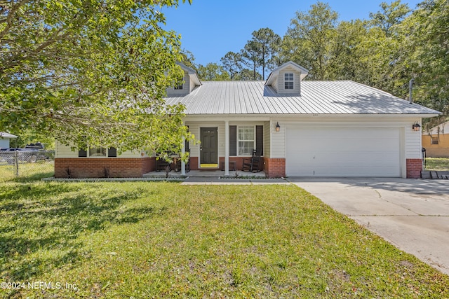 view of front of house with covered porch, a front lawn, and a garage