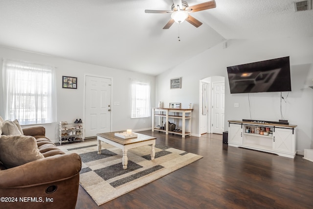 living room featuring lofted ceiling, ceiling fan, a textured ceiling, and dark hardwood / wood-style flooring