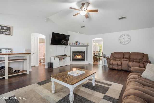 living room featuring dark hardwood / wood-style flooring, ceiling fan, and vaulted ceiling