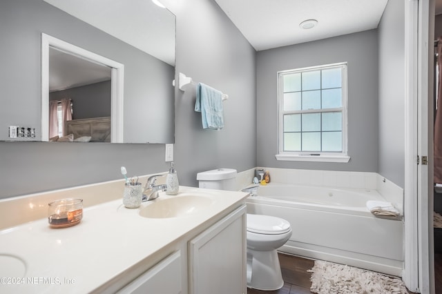 bathroom with a bathtub, toilet, wood-type flooring, and vanity