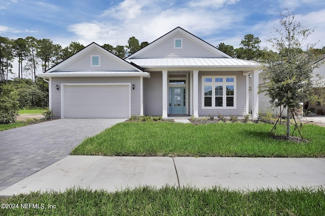 view of front of home with a front lawn and a garage