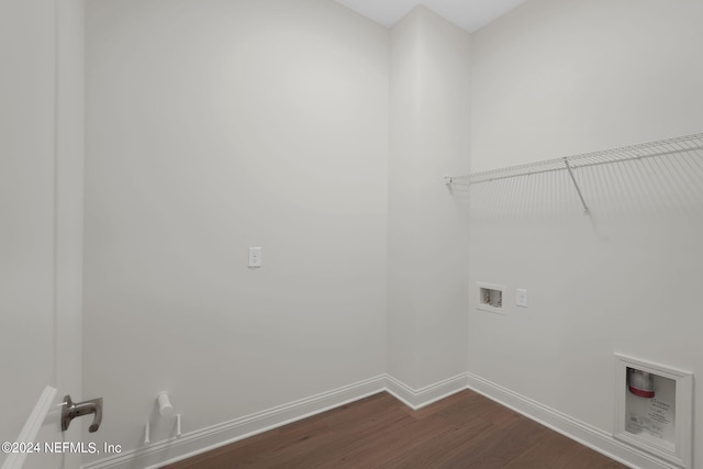 clothes washing area with washer hookup and dark wood-type flooring