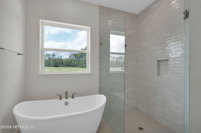 bathroom featuring independent shower and bath