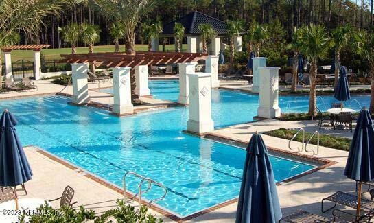 view of swimming pool with a pergola and a patio