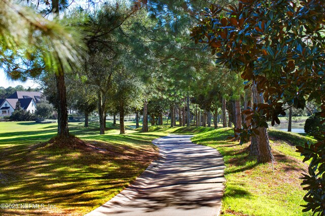 view of property's community with a lawn