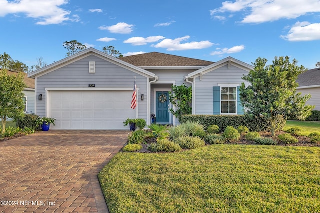 ranch-style home featuring a garage and a front yard