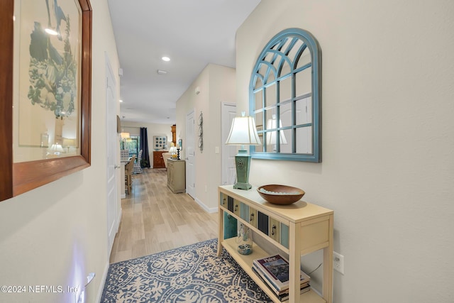 corridor with light hardwood / wood-style flooring