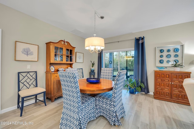 dining room featuring a chandelier and light wood-type flooring