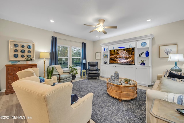 living room featuring ceiling fan and light hardwood / wood-style flooring