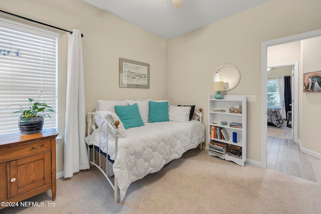 bedroom featuring light carpet and ceiling fan