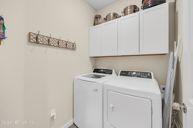 laundry room featuring cabinets and separate washer and dryer