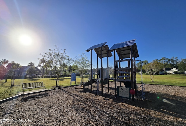 view of playground with a lawn