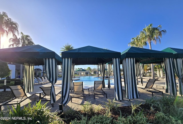 exterior space featuring a gazebo and a community pool