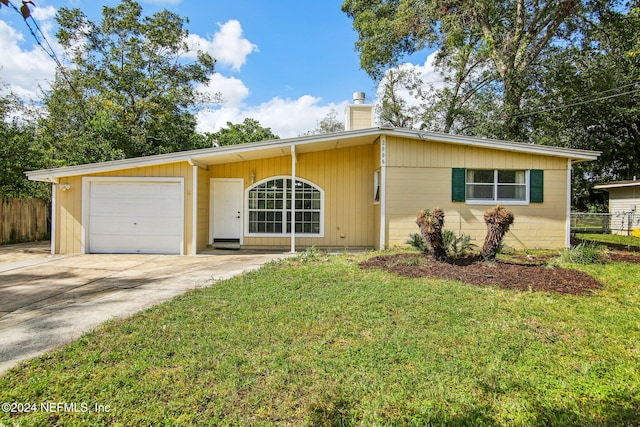 ranch-style house featuring a garage and a front lawn