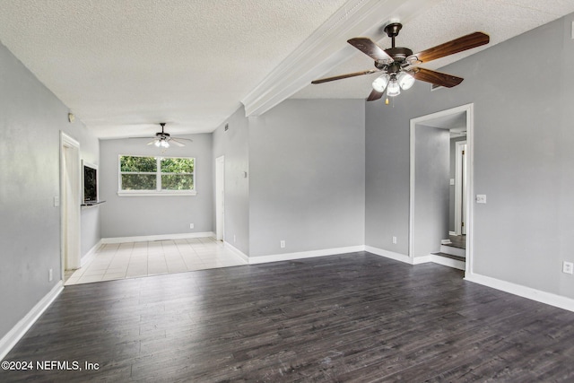 unfurnished room with a textured ceiling, hardwood / wood-style flooring, and ceiling fan