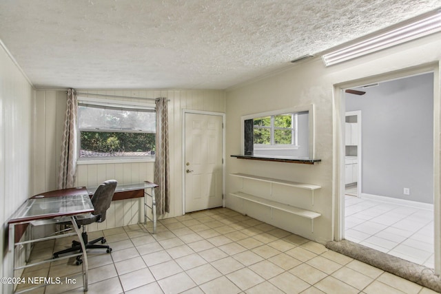 tiled home office with a textured ceiling and vaulted ceiling