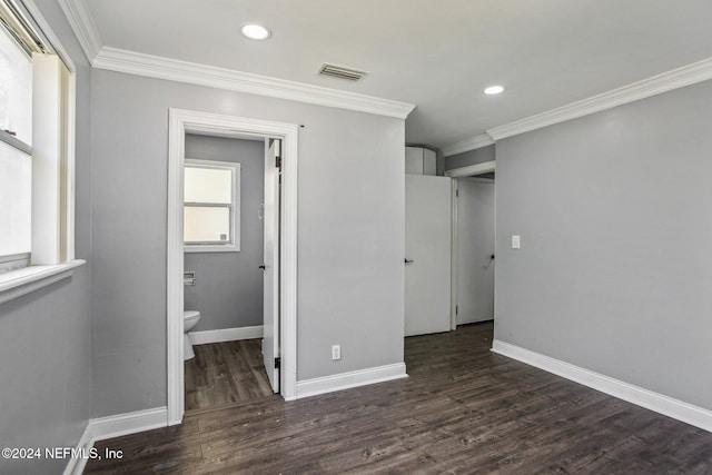 unfurnished bedroom featuring dark hardwood / wood-style flooring, connected bathroom, and ornamental molding