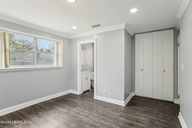 unfurnished bedroom with ensuite bathroom, ornamental molding, and dark hardwood / wood-style floors