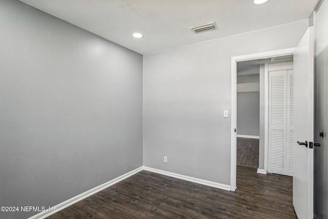 empty room with dark hardwood / wood-style flooring