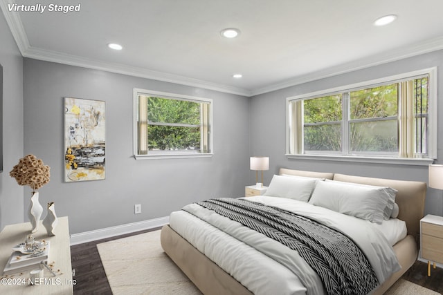 bedroom with ornamental molding, multiple windows, and dark hardwood / wood-style floors