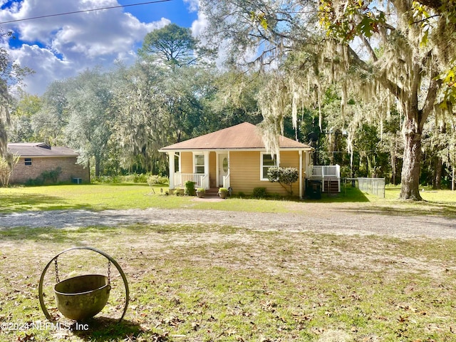 view of front of property with a front yard and covered porch