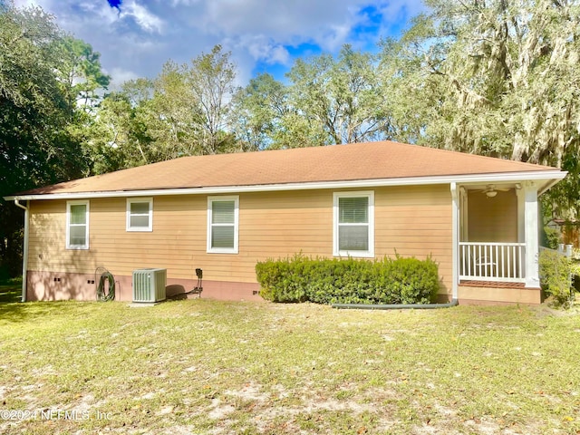 rear view of property with a lawn and central AC unit