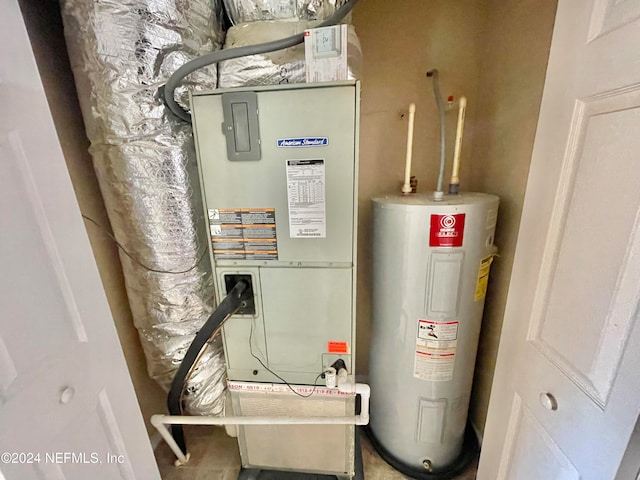 utility room featuring electric water heater and heating unit