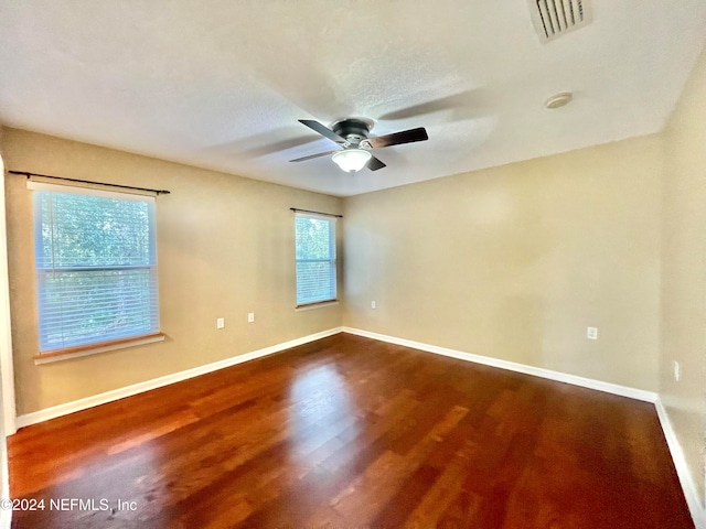 empty room featuring a textured ceiling, wood-type flooring, and ceiling fan