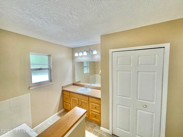 bathroom with vanity and a textured ceiling