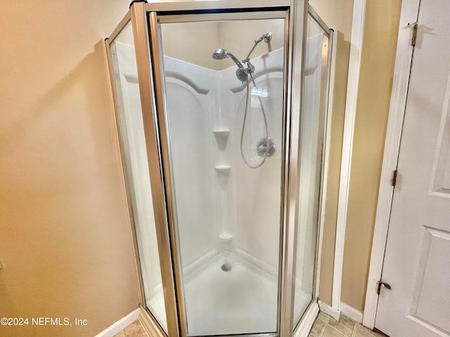 bathroom with a shower with shower door