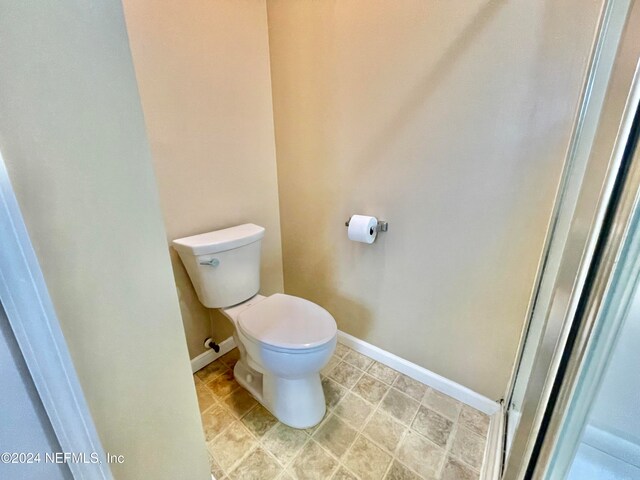 bathroom featuring tile patterned floors and toilet