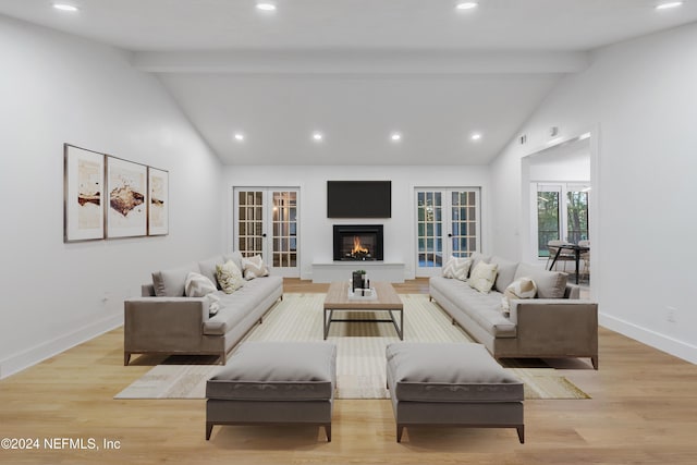 living room with french doors, light wood-type flooring, and lofted ceiling with beams