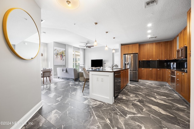 kitchen featuring stainless steel appliances, a kitchen island with sink, a kitchen breakfast bar, ceiling fan, and decorative light fixtures