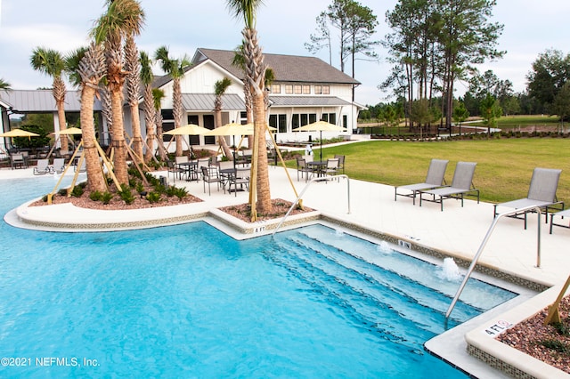 view of swimming pool featuring a lawn and a patio area