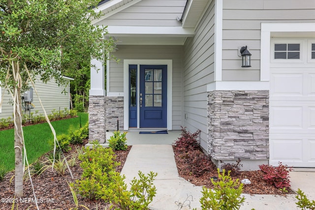 63 Bird Watch Ct, Saint Augustine, FL 32092 - doorway to property with stone siding and a garage