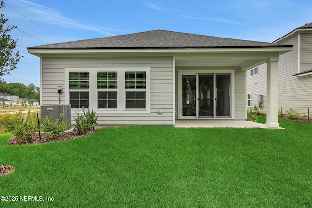 63 Bird Watch Ct, Saint Augustine, FL 32092 - back of house featuring cooling unit, a lawn, a patio, and a shingled roof