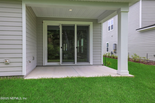 63 Bird Watch Ct, Saint Augustine, FL 32092 - view of exterior entry featuring a yard and a patio area