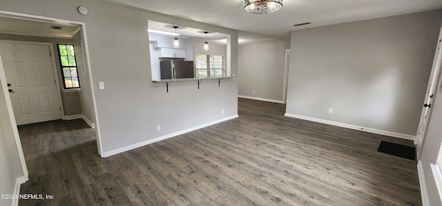 unfurnished living room with dark hardwood / wood-style floors