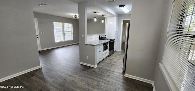 kitchen with a wealth of natural light, white cabinets, stainless steel range with electric stovetop, and dark hardwood / wood-style floors