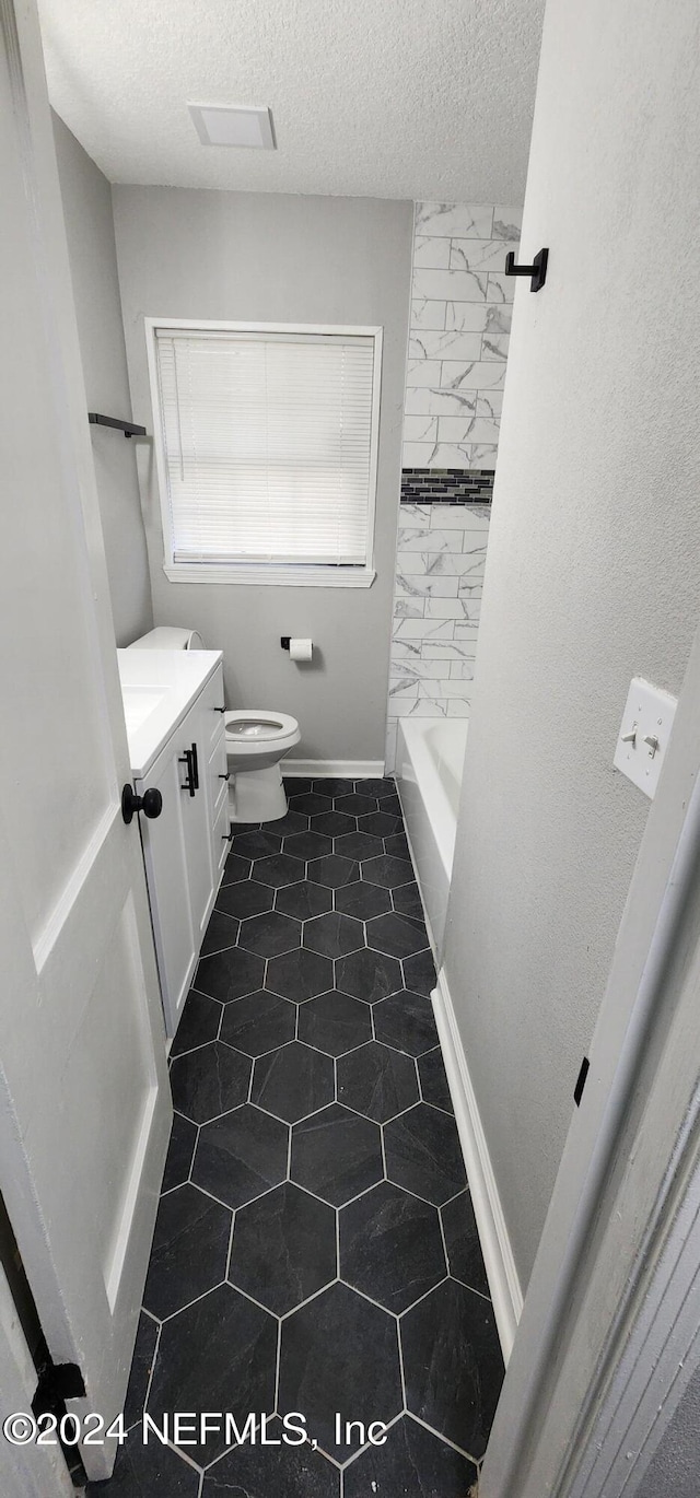 full bathroom featuring vanity, shower with separate bathtub, a textured ceiling, and toilet