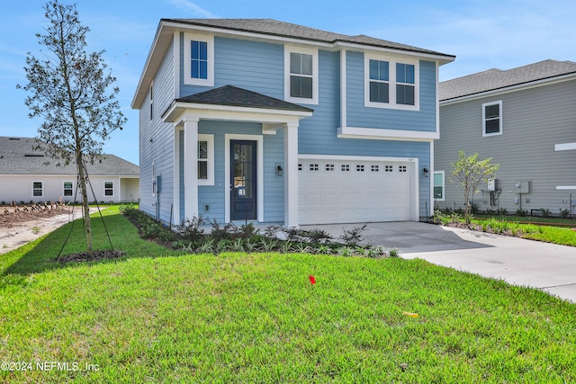 front of property featuring a garage and a front lawn