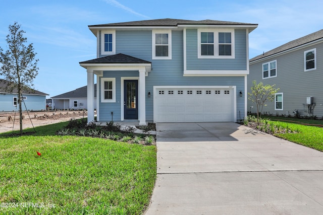 front of property with a garage and a front lawn