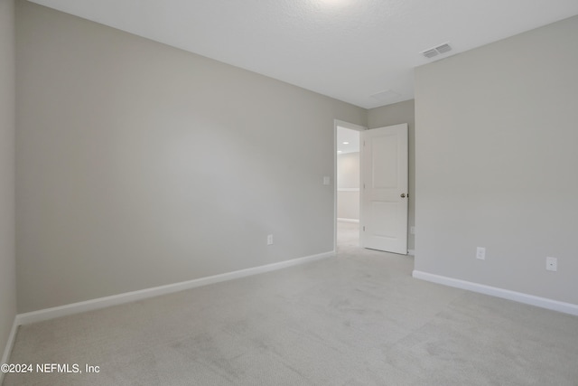 spare room with light colored carpet