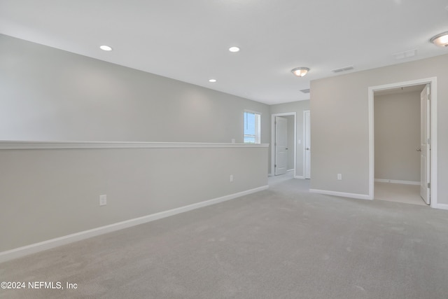 empty room featuring light carpet