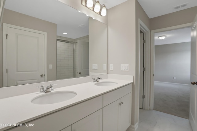 bathroom with vanity and a shower with shower door