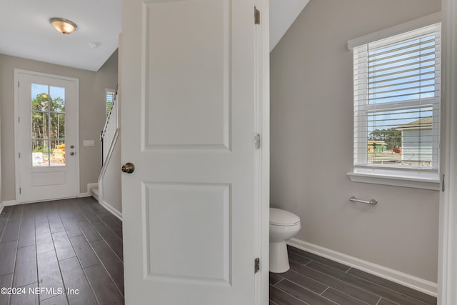 bathroom with wood-type flooring, toilet, and lofted ceiling