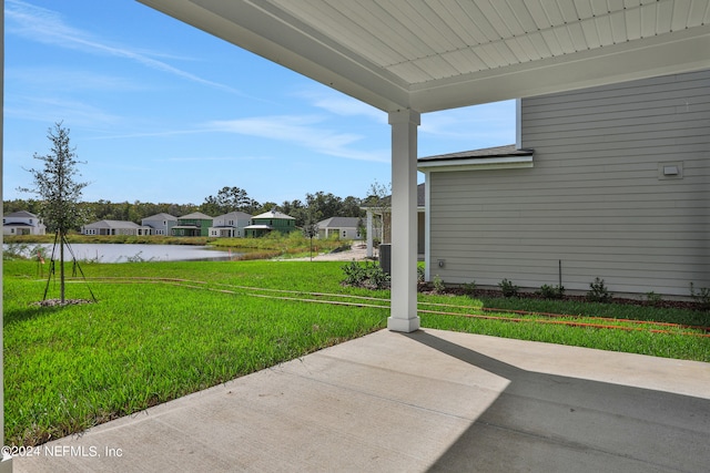 view of yard featuring a patio and a water view