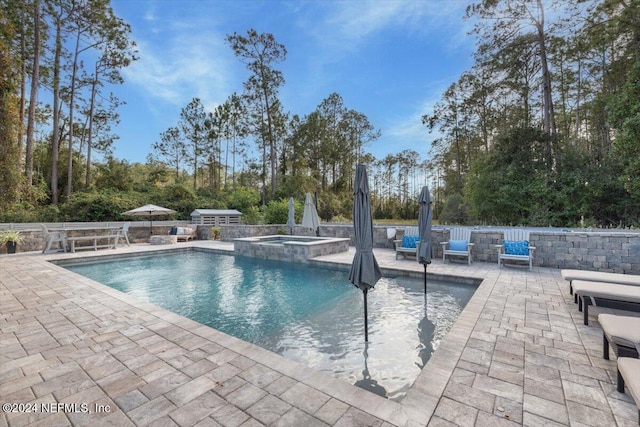 10225 Russell Sampson Rd, Saint Johns, FL 32259 - view of pool featuring a patio, a pool with connected hot tub, and view of wooded area