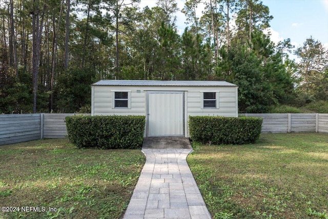 view of outbuilding featuring a lawn